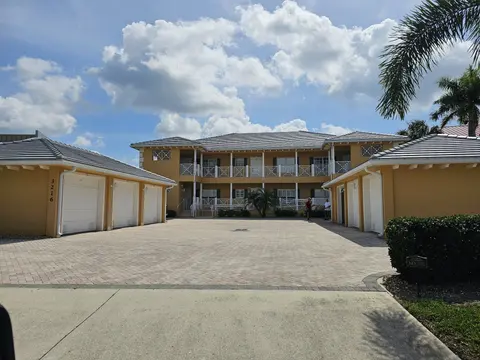 Two-story building with tile roof and new seamless gutters over the garages